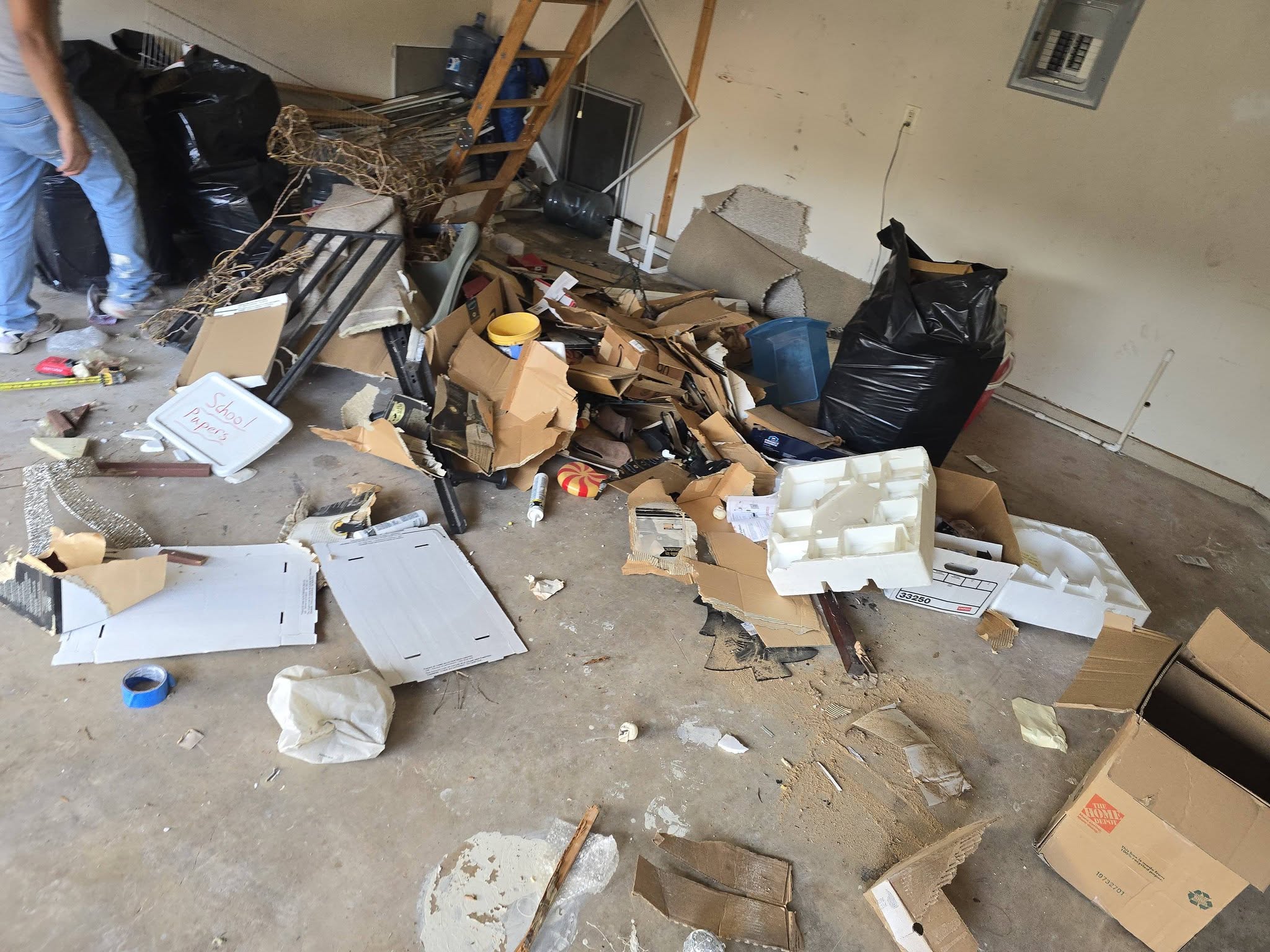 American Valor Waste crew clearing debris during a residential garage cleanout in San Antonio