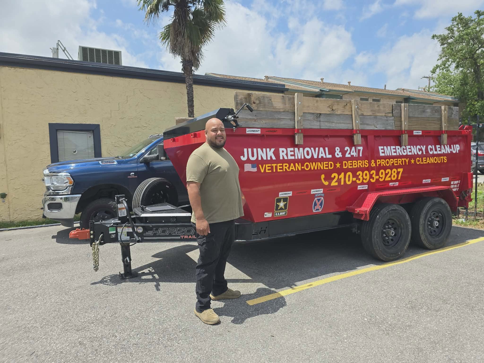 American Valor Waste crew member with the company's veteran-owned junk removal trailer in San Antonio, TX